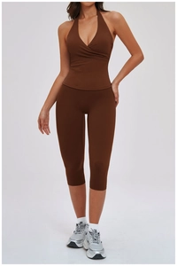 Detail of high-stretch halter neck top and matching brown capri leggings for yoga training