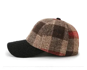 Side view of checkered tweed baseball cap with brown and red pattern and black brim