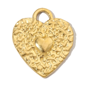 Detailed view of heart-shaped gold plated pendant with hammered texture and smooth center