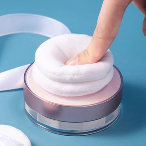 White flocking powder puff set with pink metallic trim case shown for softness