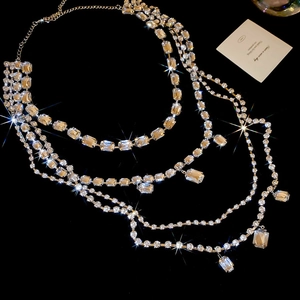 Detail of layered silver tassel necklace with square crystals and sparkling rhinestone finish