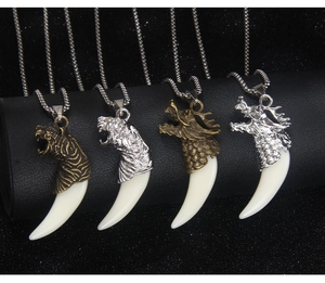 Detailed view of four dragon and tiger head necklaces with faux wolf tooth pendants