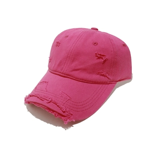 Detail shot of distressed rose pink cotton baseball cap with vintage frayed edges