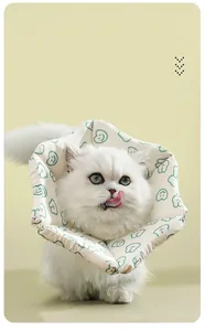 Detail view of a soft cotton cat recovery collar on a white cat for post-surgery protection