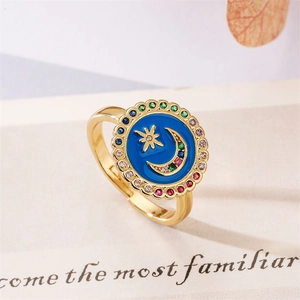 Macro detail of adjustable gold moon star ring with blue enamel and colorful zircon border
