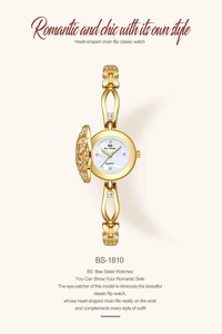 Detail of BS Bee Sister gold watch with heart-shaped crystal cover and pearl dial