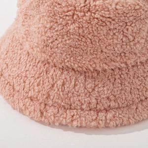 Plush pink faux fur bucket hat for winter featuring soft lamb wool texture for warmth
