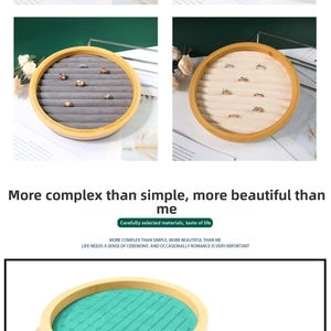 Detail of round bamboo jewelry tray with multiple velvet slots for rings and studs