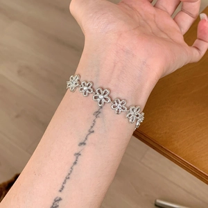 Elegant silver lace flower bracelet with zircon stones on female wrist lifestyle view