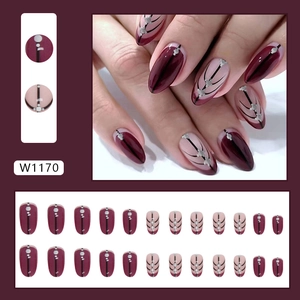 Deep burgundy and nude press-on nails with geometric black lines and silver metallic dots