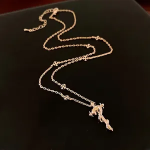 Vintage gothic golden sword pendant necklace with small cross ornaments and chain detailing