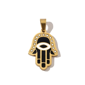 Detailed view of gold Hamsa hand pendant with colorful enamel and zircon stones