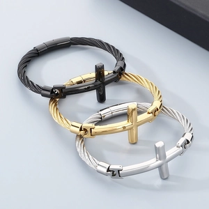 Detail of cross bangles in gold, silver and black with braided steel wire texture
