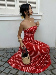 Detail of red polka dot off-shoulder dress with elegant waist design and flowing fabric