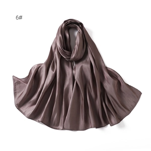 Close-up of elegant dark mauve satin scarf featuring silky smooth texture and pearl luster