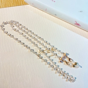 Detail of crystal beads and gold lobster clasp on a multi-use eyewear chain