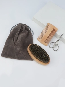 Macro shot of 4-piece men's beard grooming kit with wooden brush and steel scissors