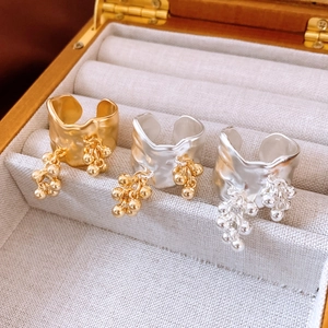 Detail of 18K gold plated irregular pleated rings with fringe beads in a jewelry box