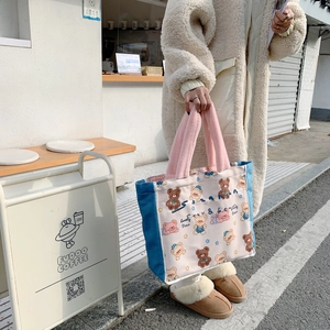 Detail of the Lovely Bear tote bag with pink plush handles and navy canvas side panels