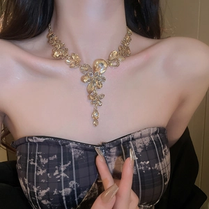 Close-up of luxury Y-shaped necklace with crystal flower and pear-cut drop pendant