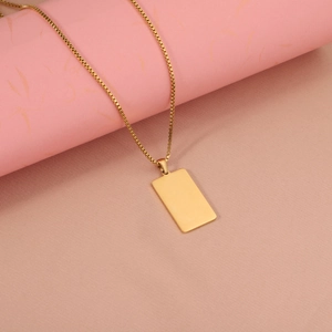 Detailed view of polished gold rectangular bar pendant with fine box chain necklace