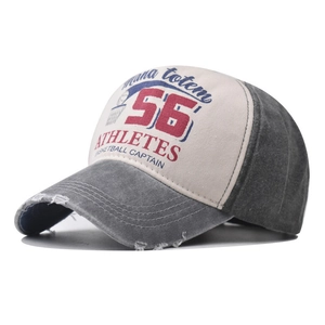 Detailed view of vintage distressed baseball cap with 56 athletes print and frayed brim