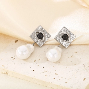 Detail of silver square stud earrings with evil eye opal and baroque pearl drop