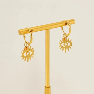 Golden stainless steel evil eye hoop earrings on a display stand with a white background