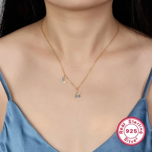 Elegant 925 sterling silver gold necklace with star and moon pendant on female model