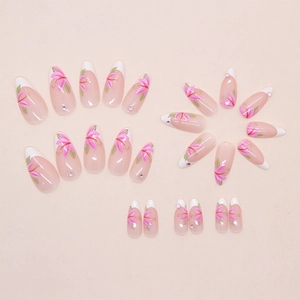 Detail of almond-shaped press-on nails with white French tips and pink floral nail art