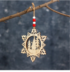 Detailed close-up of a three-layer wooden snowflake gnome ornament hanging on a pine tree