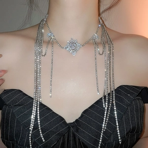 Close-up of sparkling zircon tassel necklace with snowflake pendant on a female model
