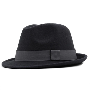 Detail of dark gray grosgrain ribbon band on a black wool felt fedora jazz hat