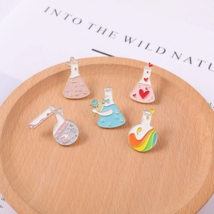 5er-Set Emaille-Pins mit Herzflaschen und Regenbogen-Bechern auf einem Holztablett