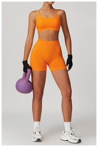 Close-up of orange seamless high-waist yoga shorts fabric and athletic texture detail