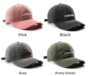Detail view of retro denim baseball caps with CONQUER embroidery in four colors