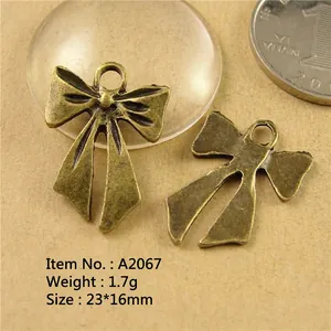 Zinc alloy bow pendants in vintage bronze finish with detailed size 23x16mm macro view