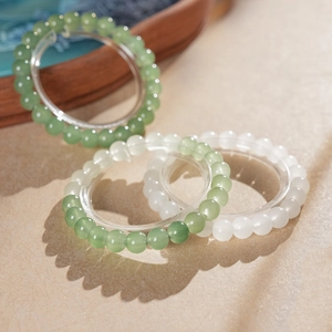 Close-up of green and white jade beads bracelet with elegant polished semi-transparent finish