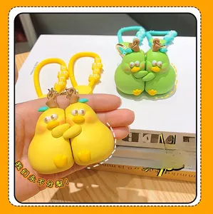 Detailed close-up of cartoon pear duck keychain showing matte silicone embrace texture