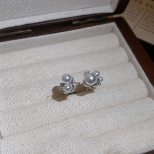 Detailed view of pearl and zircon ring in a velvet jewelry box display