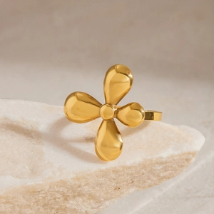 Elegant gold stainless steel floral ring with polished four-petal flower design on stone