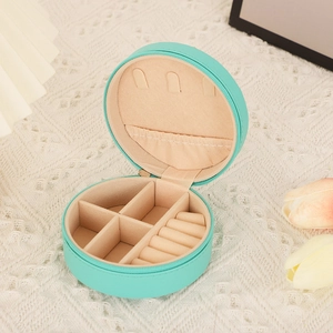 Detail view of mint green circular PU leather jewelry organizer with velvet interior