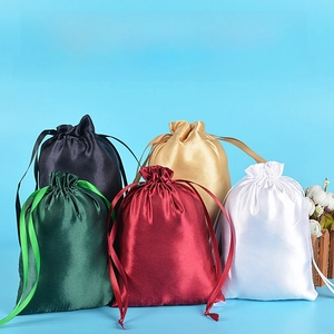 Detailed view of glossy satin drawstring gift bags in multiple premium colors