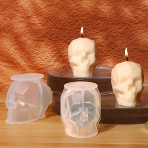 Detailed view of 3D geometric skull silicone mold and finished candle with faceted design