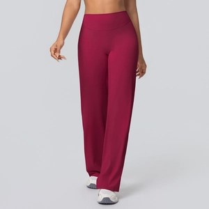 Detail view of burgundy high-waist flared yoga pants featuring elastic moisture-wicking fabric