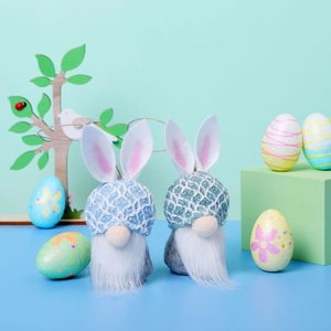 Close-up of Easter gnomes with rabbit ears and white beards against a pastel background