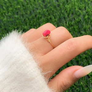 Handmade wire wrapped ring with pink gemstone and gold finish in bohemian style