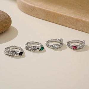 Set of four 18k gold plated snake rings with pear-shaped stones and engraved scales