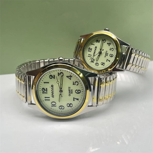 Close-up of wecin couple quartz watches with gold-silver elastic bands and big numerals