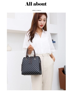Detailed view of dark grey handbag featuring a geometric diamond lattice pattern and double handles